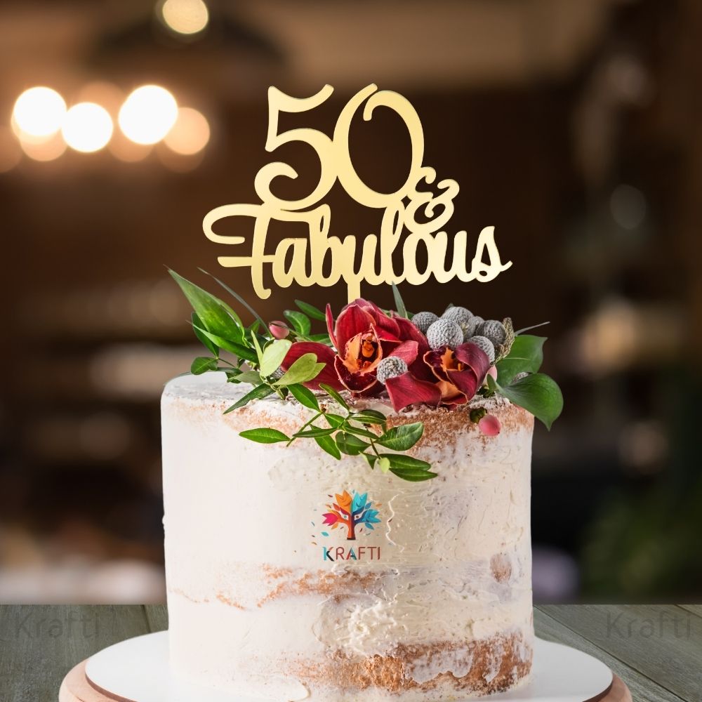 50 Fabulous gold acrylic 50th birthday cake topper displayed on a decorated celebration cake
