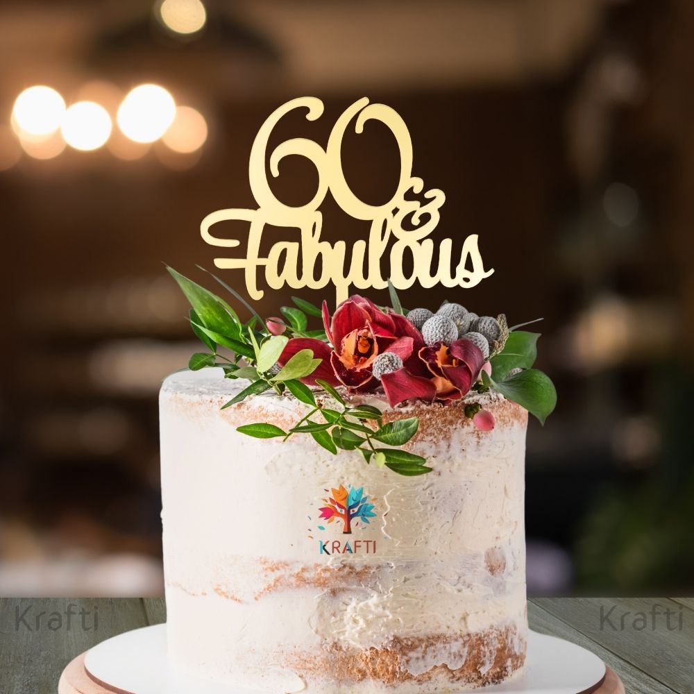 60 Fabulous gold acrylic 60th birthday cake topper displayed on a decorated celebration cake